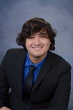 man smiling in front of grey background