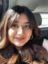 woman smiling while sitting in a car