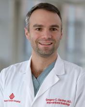 man in a texas childrens doctor coat smiling