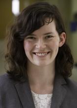 woman with dark wavy, shoulder length hair smiling