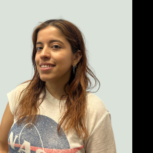 woman smiling in front of grey background