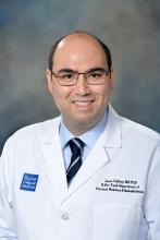 man with square glasses on smiling