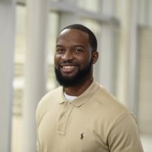 Man smiling in front of white background