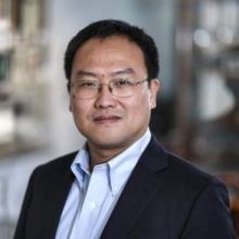 man smiling in front of grey background