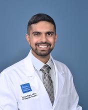 man in white doctor coat smiling