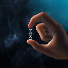 Hand holding dna-style double helix in front of a blue background