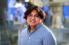 man with short hair and glasses on smiling