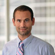 man with buzz cut smiling