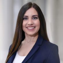 woman smiling in front of grey background