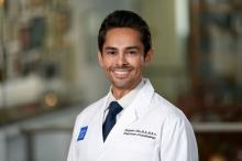 man with short dark hair smiling