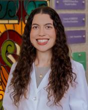 woman with long, curly brown hair smiling