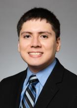 man with short, dark brown hair smiling