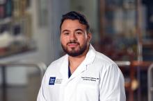 man with short dark hair smiling