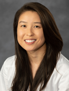 woman with straight, long dark hair smiling