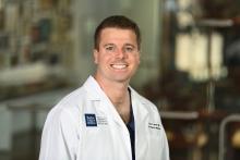 man with short brown hair smiling