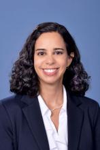woman with curly dark hair smiling