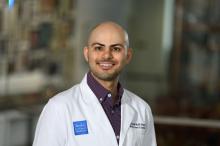 man with very short buzz cut smiling