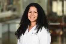 woman with long curly hair smiling