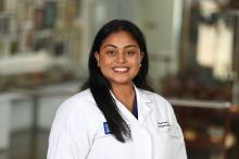 woman with long, dark straight hair smiling