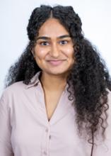 woman with long curly hair smiling