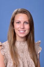 woman with long, dark blonde hair smiling