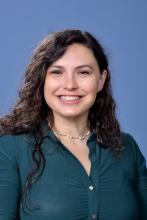 woman with long curly hair smiling