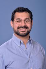 man with short beard and glasses on smiling
