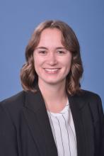 woman with short, dark blonde hair smiling