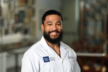 man with short hair and a beard smiling