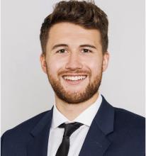 man with light brown hair smiling