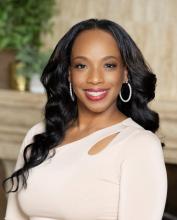 woman with long curledd hair smiling