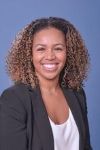 woman with short curly hair smiling