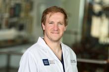 man with dark blonde hair smiling