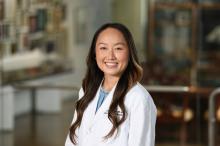 woman with long curled hair smiling