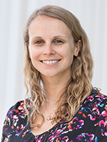 woman with curly blonde hair smiling