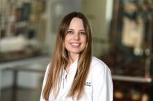 woman with long, dark blonde hair smiling