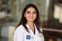 woman with long hair and glasses on smiling
