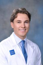 man with short wavy hair smiling