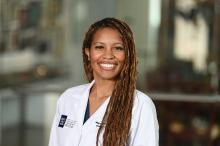 woman with long, side parted hair smiling