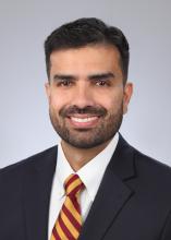 man ina red and yellow striped tie smiling