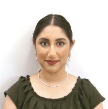 woman with her hair pulled back smiling