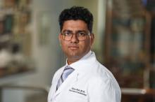 man with dark hair and glasses