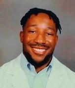 man in a doctor coat smiling