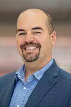 man with a goatee smiling