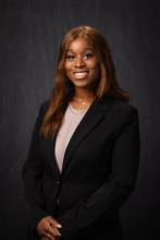 woman in a dark suit smiling