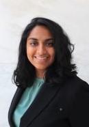 woman with curled shoulder length hair smiling