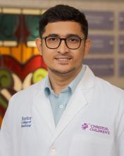 man with dark glasses on smiling