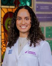 woman with medium length curly hair smiling