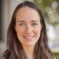 woman smiling in front of grey background