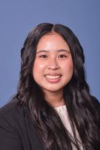 woman with dark curled hair smiling